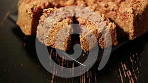 Oatmeal pie on a black plate on a black table