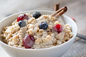 Oatmeal porridge with berries, close up