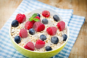 Oatmeal porridge with berries. Raspberries and blueberries.