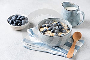 Oatmeal porridge with blueberries in bowl