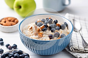 Oatmeal porridge bowl with blueberries and almonds