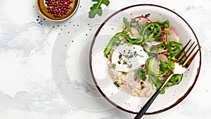 Oatmeal porridge breakfast with poached egg and fresh vegetables. Healthy balanced food. Long banner format, top view
