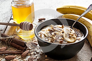 Oatmeal porridge in ceramic bowl with a spoon. healthy breakfast