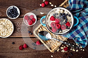 Oatmeal porridge with fresh berries, oats with blueberry and raspberry photo