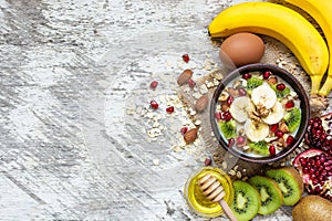 Oatmeal porridge with fruits, nuts and honey. healthy breakfast