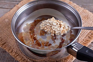 Oatmeal porridge in a saucepan