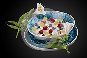 Oatmeal porridge with seasonal berries. On a dark background. Breakfast