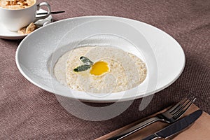 Oatmeal porridge with white round plate