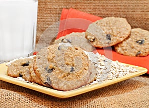 Oatmeal raisin cookies with milk.