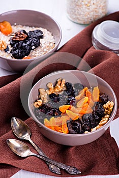 Oatmeal with raisins, dried apricots, plums in the bowl