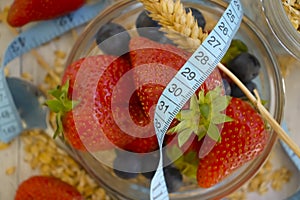 Oatmeal, strawberry, blueberry measuring tape close-up