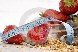 Oatmeal, strawberry, blueberry measuring tape close-up vegetarian