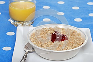 Oatmeal with strawberry jam and orange juice