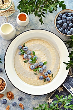 Oatmeal with walnuts and blueberries. Healthy breakfast.