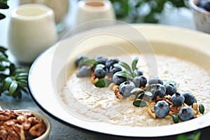 Oatmeal with walnuts and blueberries. Healthy breakfast.