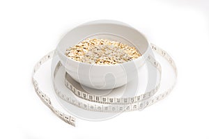 Oatmeal in white plate and centimeter on white background