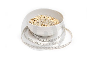 Oatmeal in white plate and centimeter on white background