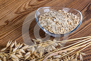 Oats and flakes on a wooden table