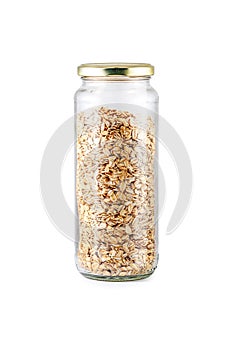 Oats in glass jar isolated on white background. Jar filled with Rolled Oats.