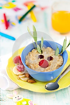Oats porridge with raspberries as a reindeer for kids