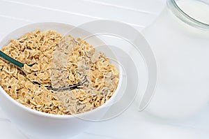 Oats in white bowl and pitcher with milk