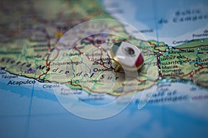 Oaxaca pinned on a map with the flag of Mexico