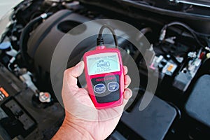 OBD2 or OBD scanner in a auto mechanic hand for engine system analysis