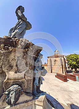 Obdulio FernÃ¡ndez Pando Monument and Oliva church in background, Villaviciosa, Principality of Asturias, Spain photo