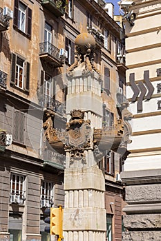 Obelisc with ancient ship hull in front of renaissance Palazzo della Borsa, Naples, Italy