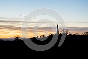 The Obelisk at Eastnor, Herefordshire silhouetted against the sunset on a winters afternoon. UK