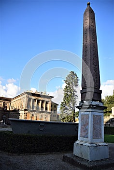 Obelisk, silhouetted in the blue sky, inside Palazzo Pitti in Florence.