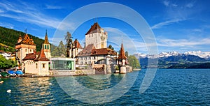 Oberhofen castle an Alps mountains, Lake Thun, Switzerland