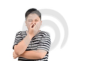 Obese boy holding his nose because of a bad smell