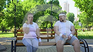 Obese couple discussing diet, healthy nutrition, common interest in weight loss