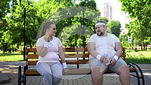 Obese couple discussing diet, healthy nutrition, common interest in weight loss