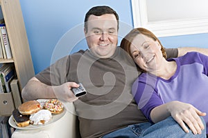 Obese Couple Watching Television