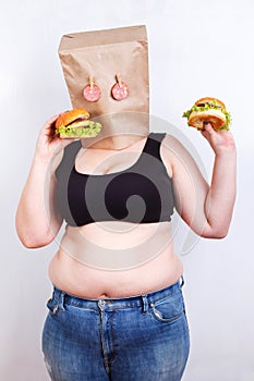 Obese fat woman with a paper bag on head like a mask with eyes
