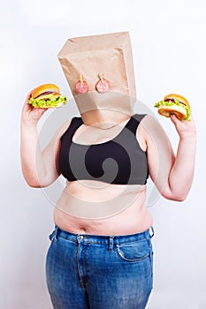 Obese fat woman with a paper bag on head like a mask with eyes