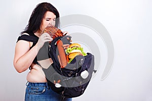 Obese fat young woman with a great backpack full of junk food on