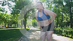 Obese girl jogging, suffocating, feels belly pain after tiresome workouts