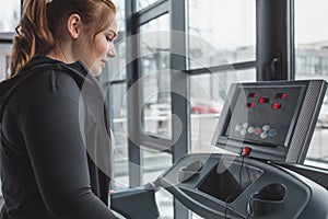 Obese girl running on treadmill