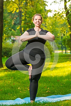 Obese girl stretches in park, daily routine for losing weight