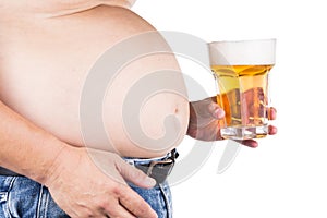 Obese man with big belly holding a glass of refreshing cold beer