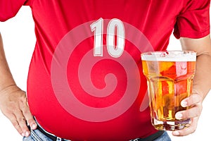 Obese man with big belly holding a glass of refreshing cold beer