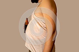 Obese man with big belly holding a glass of refreshing cold beer