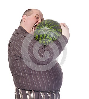 Obese man biting a watermelon