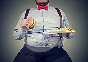 Obese man eating fast food