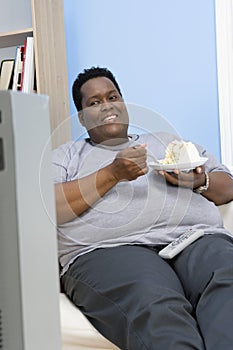 Obese Man Eating Pastry