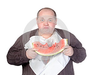 Obese man eating watermelon