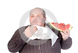 Obese man eating watermelon